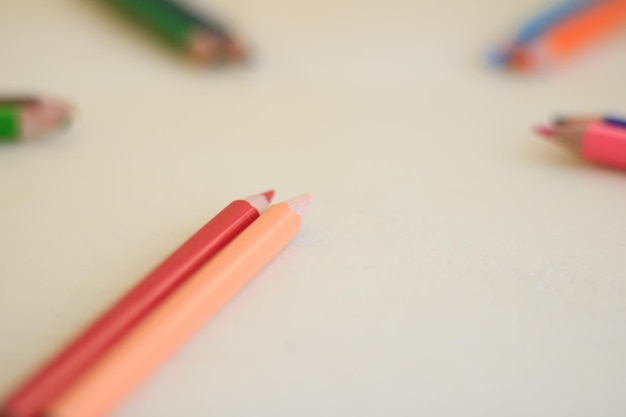 Photo colored pencils are scattered on a yellow background