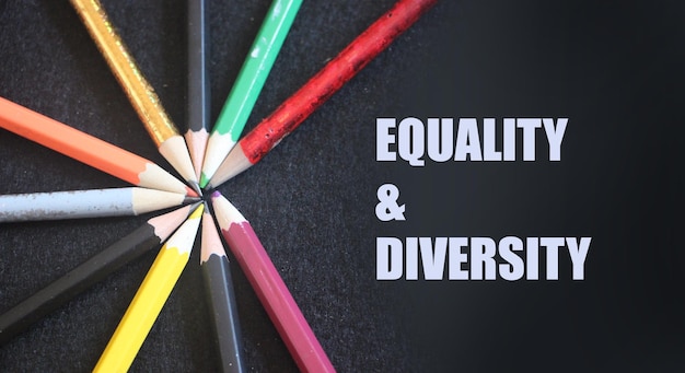 Photo colored pencils on a black background equality and diversity concept