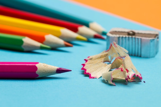 Colored pencils on a blue nd orange background