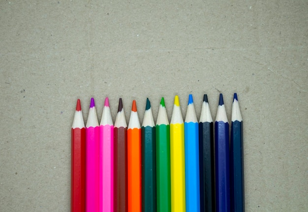 Colored pencils on a cardboard background