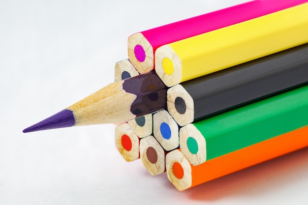 Colored pencils ends are not sharpened violet pencil sharpened on white background selective focus