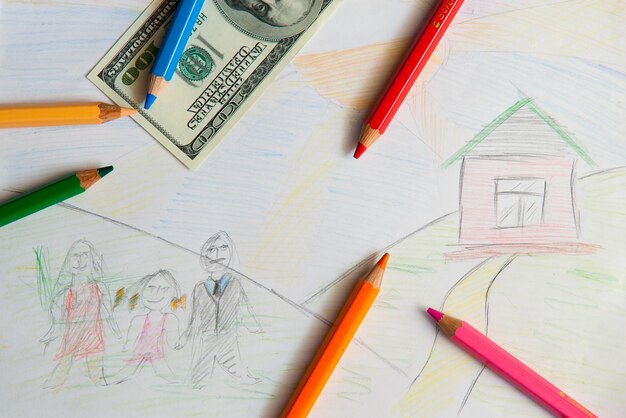 Colored pencils and us money in a pink background