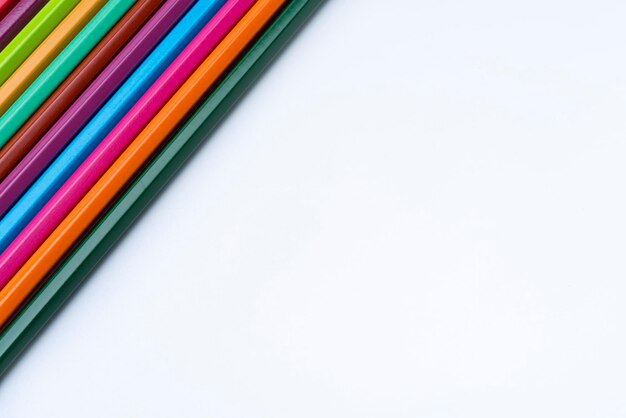 Colored pencils on a white background closeup in the upper left corner