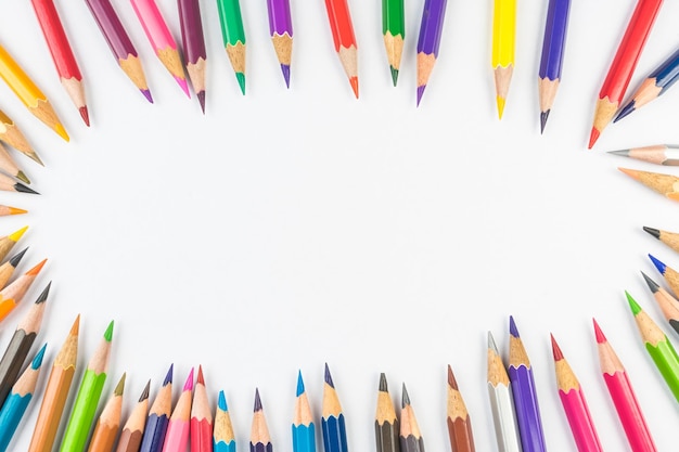 Colored pencils over white background