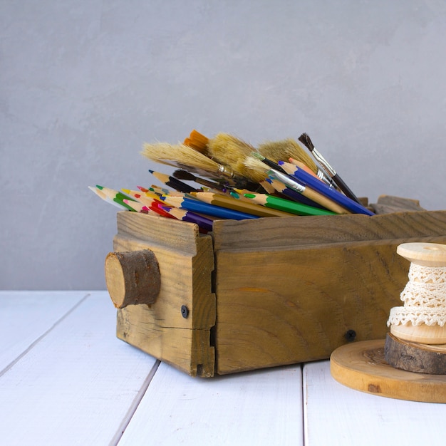 Colored pencils in a wooden box