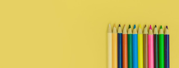 Colored pencils on a yellow panorama background