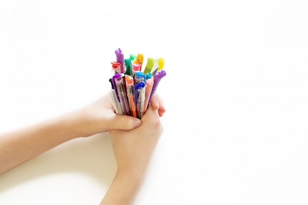 Colored pens in the hands on an isolated background