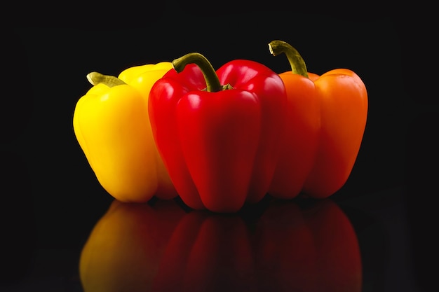 Colored pepper paprika on a black surface