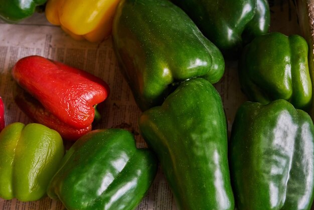 Colored peppers placed on a shelf for sale within a market