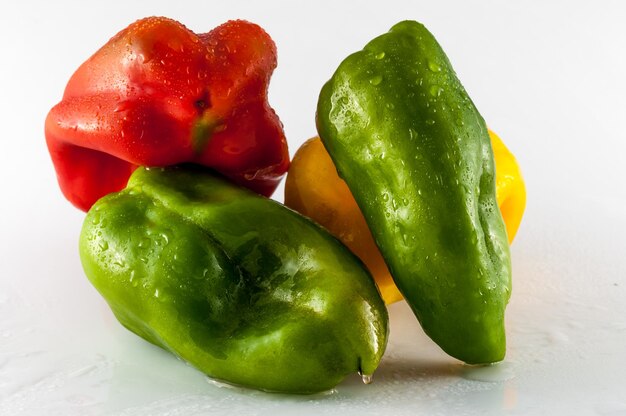 Colored peppers on white background