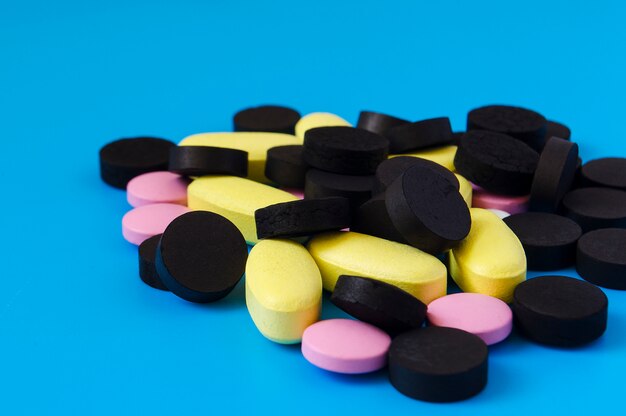 Colored pills on a blue background