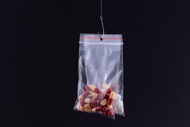 Premium Photo  Colored pills or tablets hanging in small ziplock