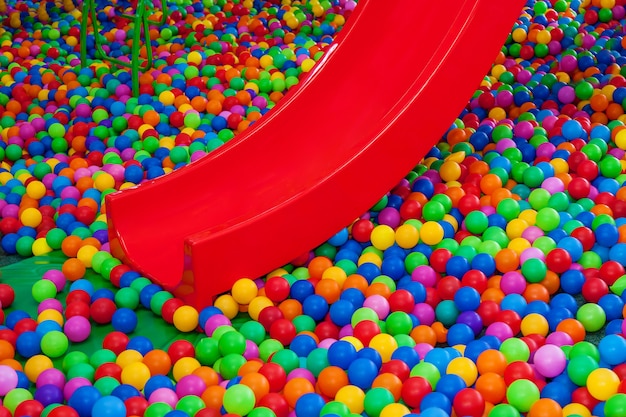 Colored plastic balls in the pool of the game room Swimming pool for entertainment with colored