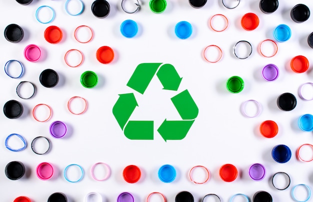 Colored plastic bottle caps with recycle symbol. World environment day or reuse, recycle concept.