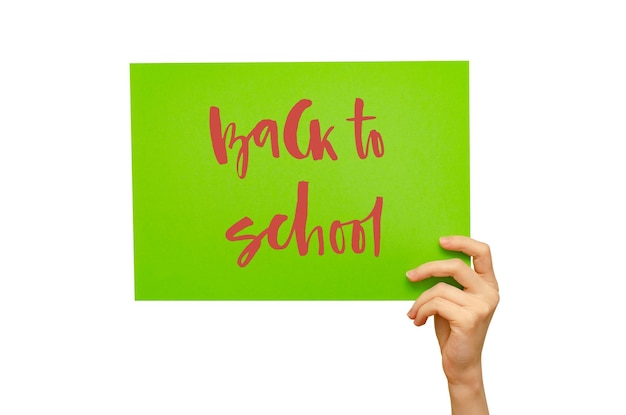 A colored poster in the girl's hand Handwritten inscription Back to school Isolated on white