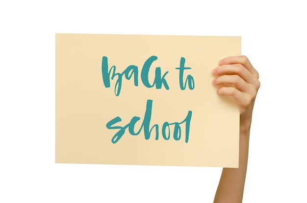 A colored poster in the girl's hand Handwritten inscription Back to school Isolated on white