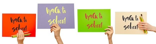 Colored posters in the girl's hand Set Handwritten inscription Back to school Isolated on white