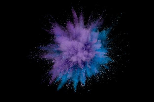 Colored powder explosion. Abstract closeup dust on backdrop. Colorful explode. Paint holi