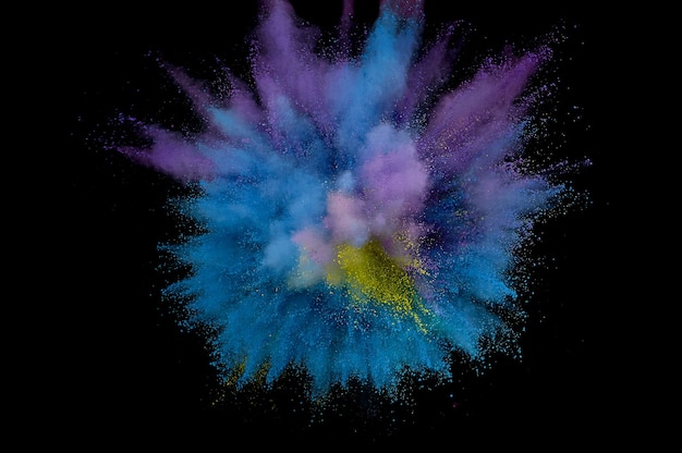 Colored powder explosion. Abstract closeup dust on backdrop. Colorful explode. Paint holi