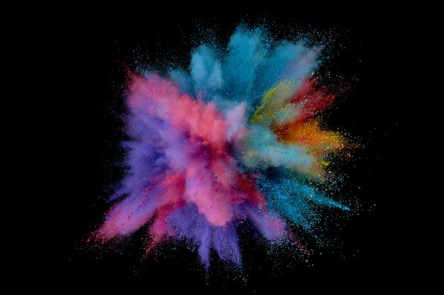 Colored powder explosion. Abstract closeup dust on backdrop. Colorful explode. Paint holi