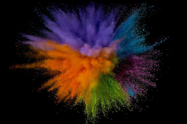 Photo colored powder explosion. abstract closeup dust on backdrop. colorful explode. paint holi