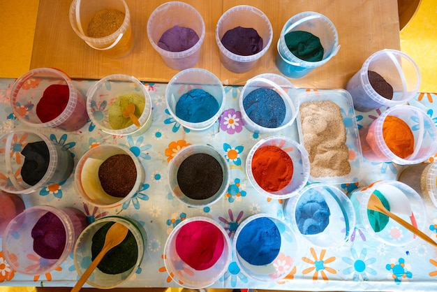 Colored sand in plastic containers perfect for art and crafts