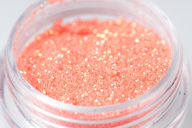 Colored sequins in a plastic jar closeup