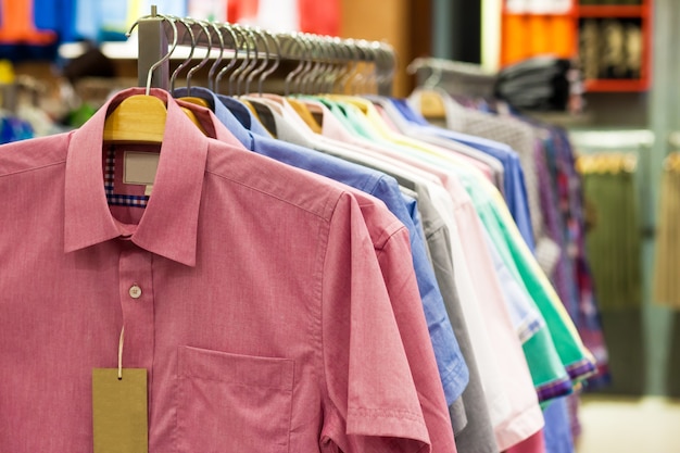 Colored shirts on hangers in a shop