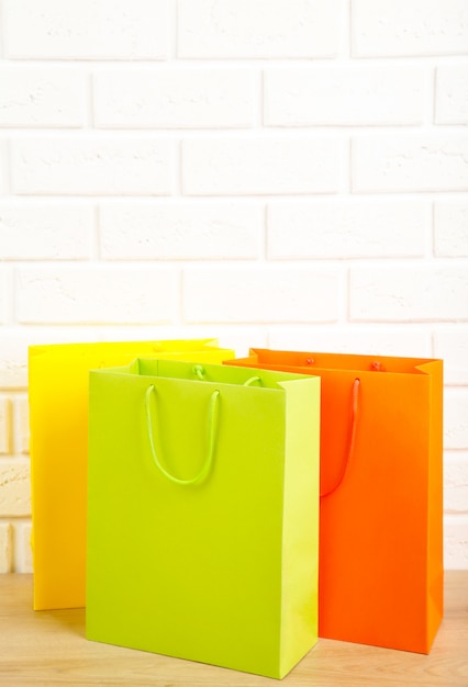 Photo colored shopping bags on the table