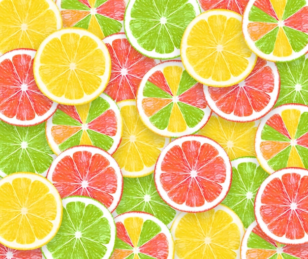 Photo colored sliced lemons background texture of fresh yellow green red fruits creative concept