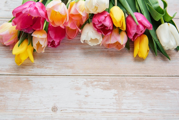 Colored spring tulips on a wooden surface