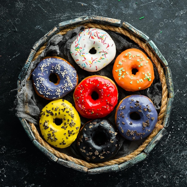 Colored sweet donuts in a wooden box Top view Flat Lay