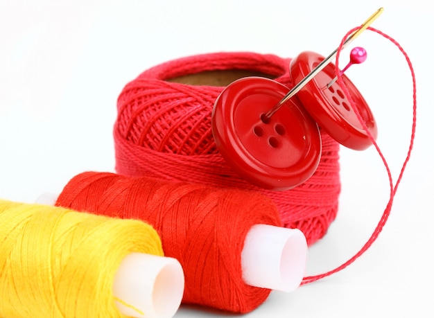 Colored threads with needles for embroidery, on a white background