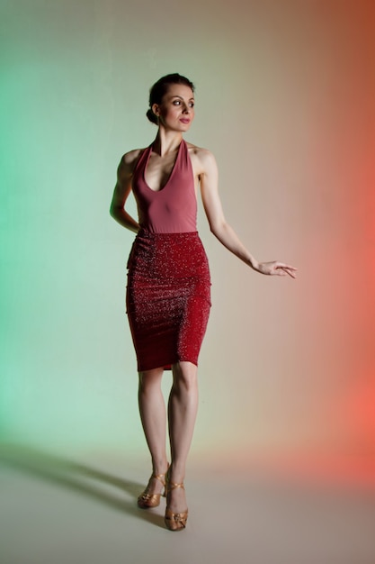 colored wall, neon lights, studio shot. portrait of a young elegant brunette woman