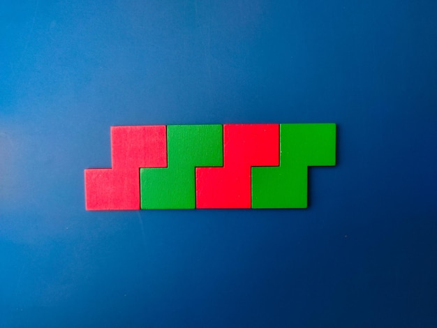 Colored wooden puzzle arranged on a blue background