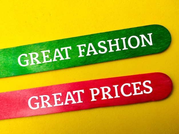 Photo colored wooden stick with the word great fashion great prices on yellow background