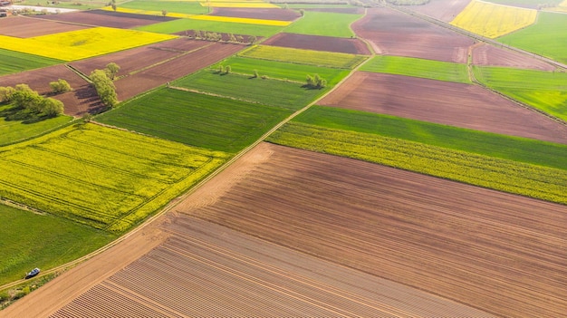 Colorful agriculture farmland at spring aerial drone view