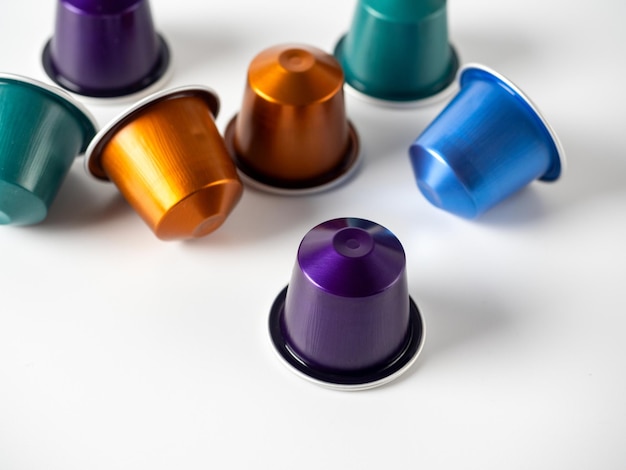 Colorful aluminum capsules with ground coffee on a white background Capsules for the coffee machine