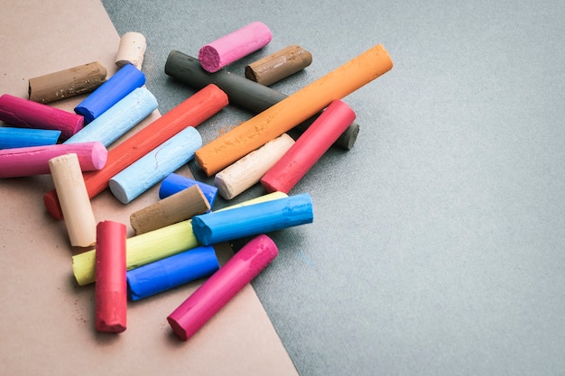 colorful art pastel crayons on a drawing paper with place for text