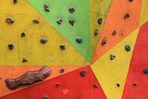 Colorful artificial rock climbing wall in close up