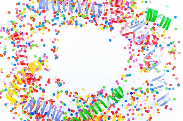 Colorful assorted confetti with serpentine on white