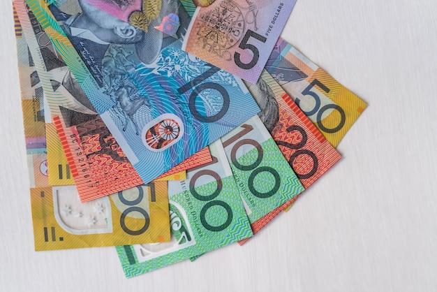 Photo colorful australian dollars laying on wooden table