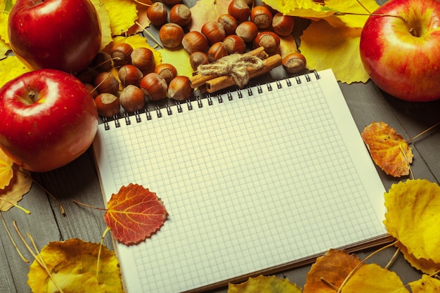 Colorful autumn leaves over wood background with copy space