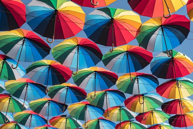 Colorful background of beautiful umbrellas against the blue sky