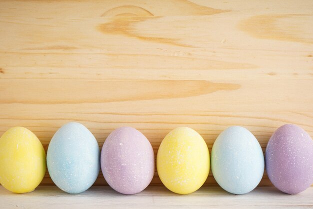 Colorful background of easter eggs on wooden background