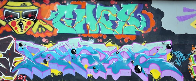 Colorful background of graffiti painting artwork with bright aerosol outlines on wall old school