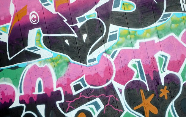 Colorful background of graffiti painting artwork with bright aerosol outlines on wall old school