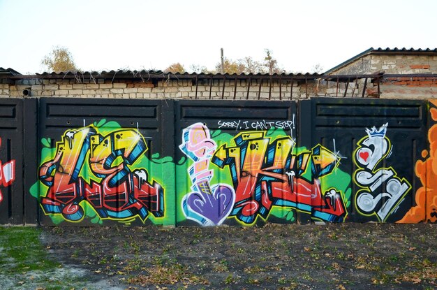 Colorful background of graffiti painting artwork with bright aerosol outlines on wall old school