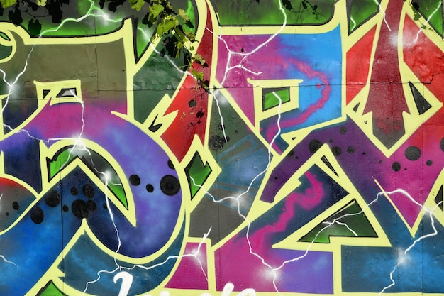 Colorful background of graffiti painting artwork with bright aerosol strips on metal wall