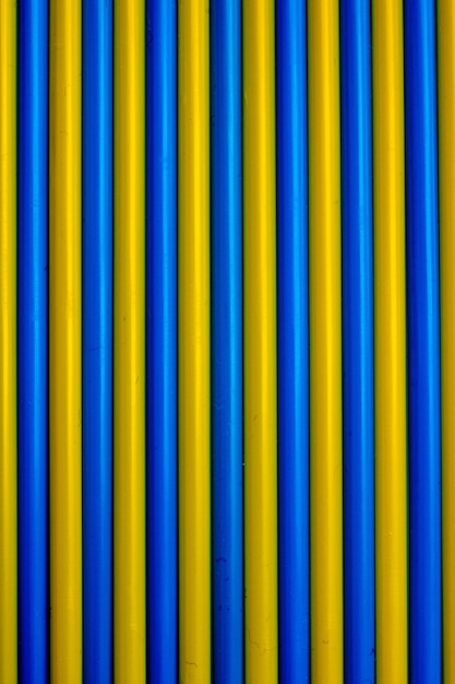 Colorful background. Multicolored plastic drinking cocktail straws. Blue and yellow backgr